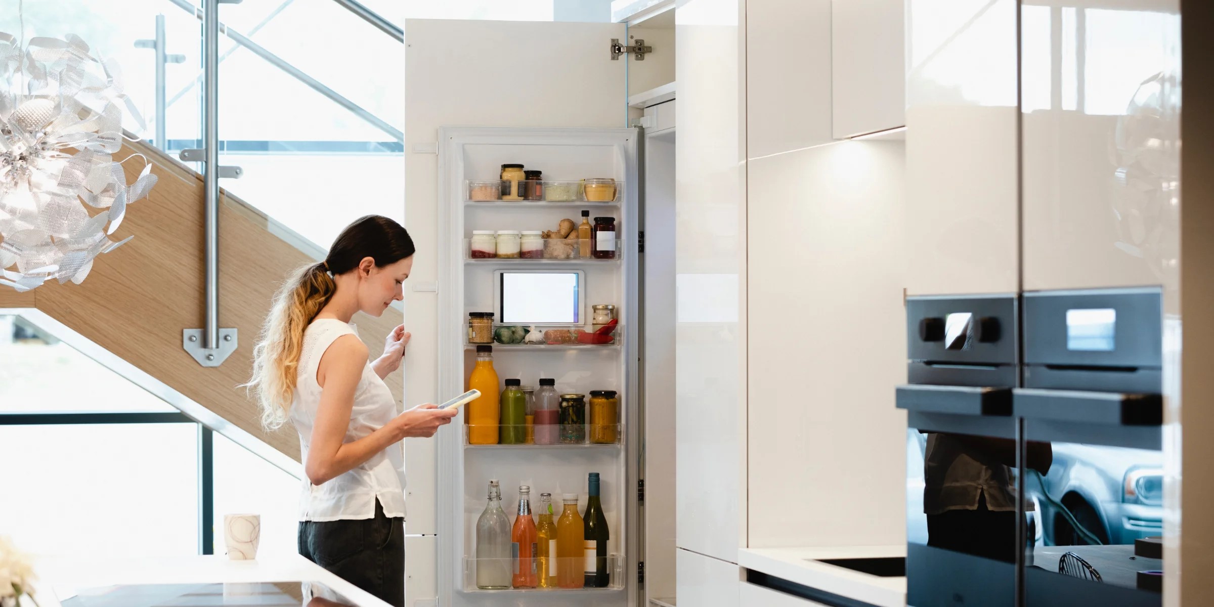 Woman looking into her fridge.