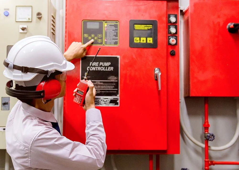 An inspector looks at a fire pump