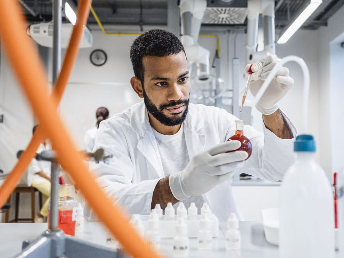 Chemist inspecting liquid in a flask