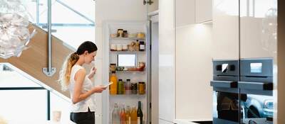 Woman looking into her fridge.