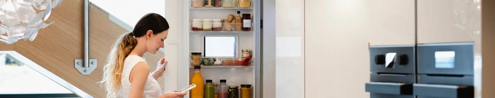 Woman looking into her fridge.