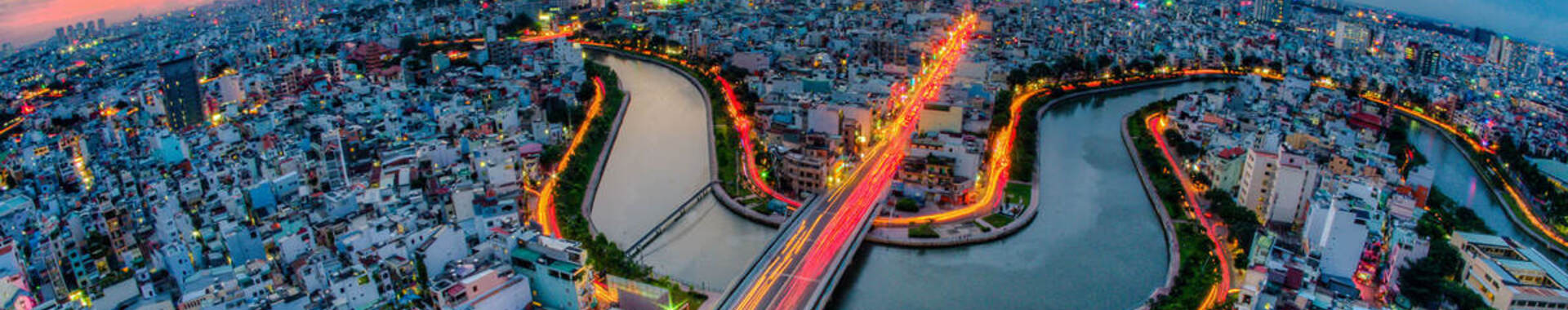 Aerial sunset view of houses and Business and Administrative Center of Ho Chi Minh City on NHIEU LOC canal